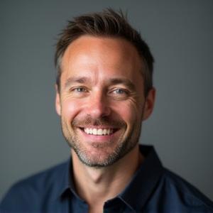 Professional headshot of Mark Peterson, co-founder of Pelagic Cycles, smiling confidently.